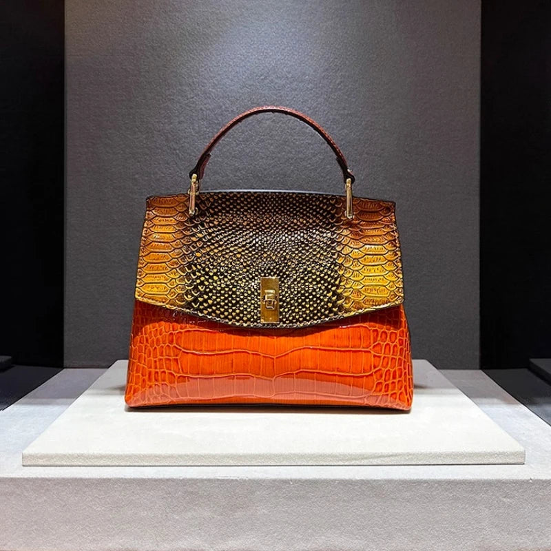 Orange embossed leather satchel bag with snake print flap