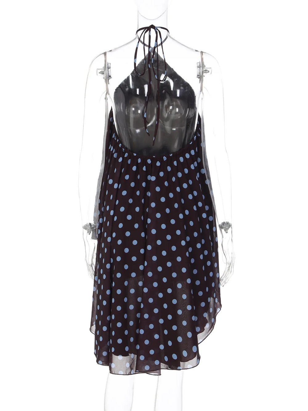 Black dress with blue polka dots on a mannequin against a white background