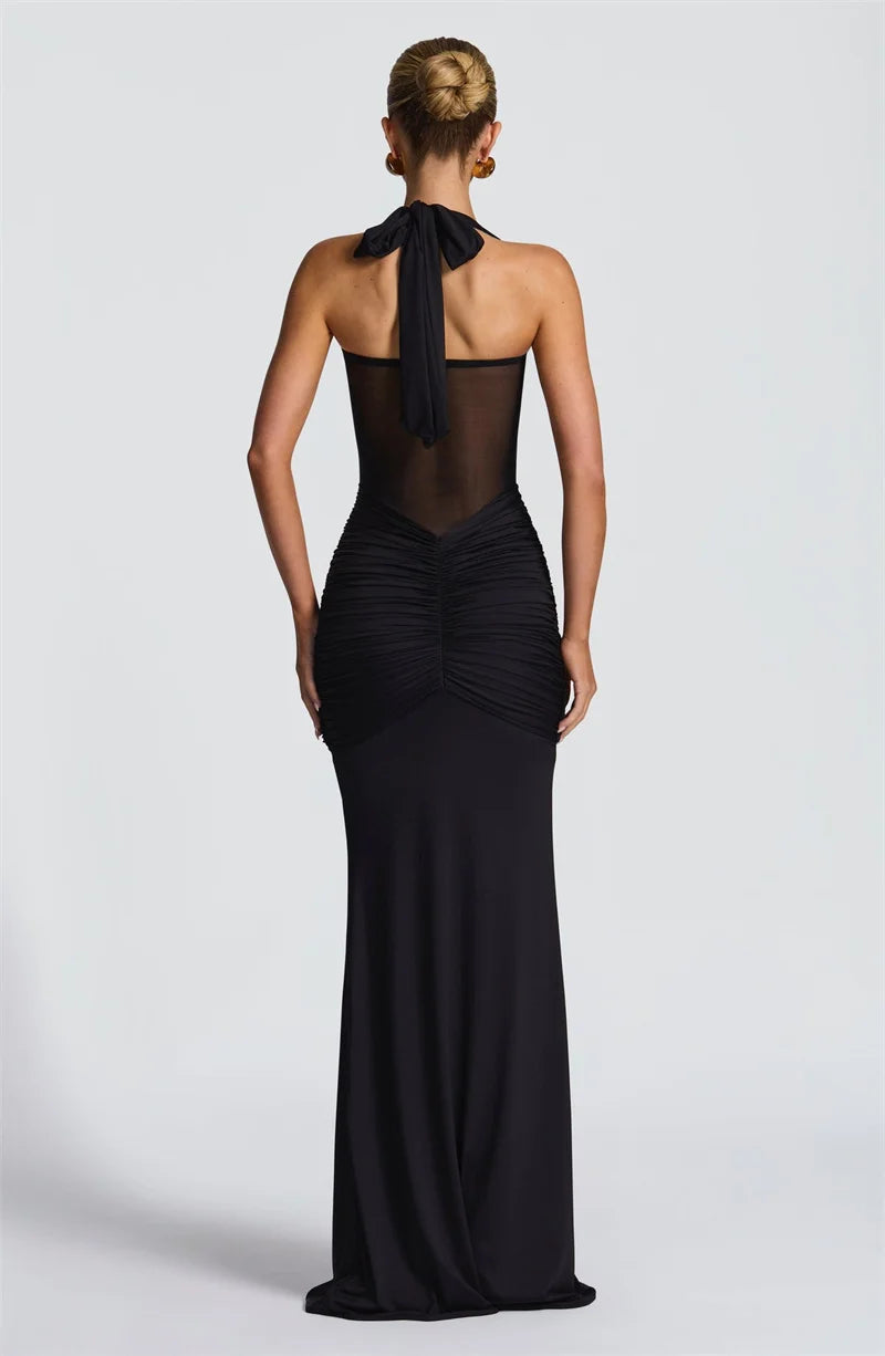 Black evening gown with sheer back on a white background