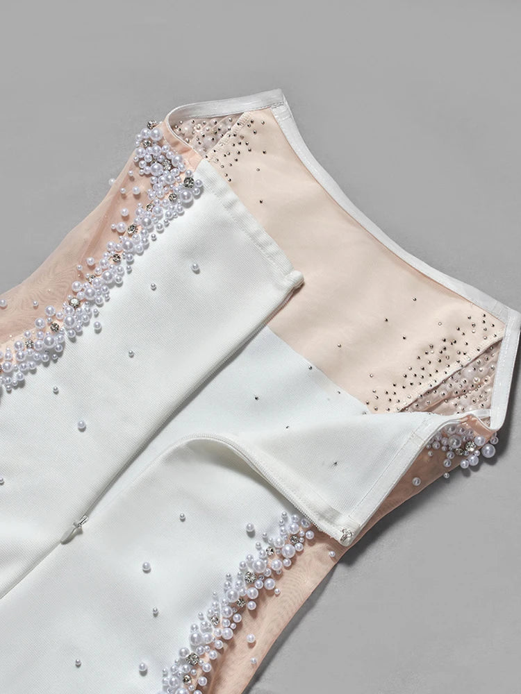 Decorative fabric with pearl and bead embellishments on a gray background