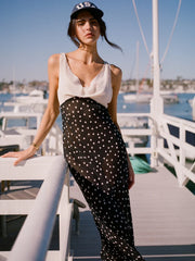 Model wearing a contrast panel polka dot maxi dress outdoors.