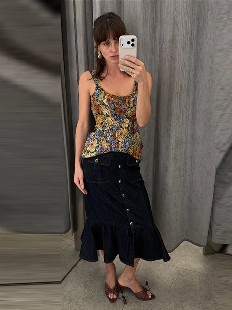 Model wearing a floral print peplum top and denim midi skirt