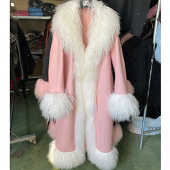 Mannequin wearing a pink coat with white fur trim in an indoor setting.