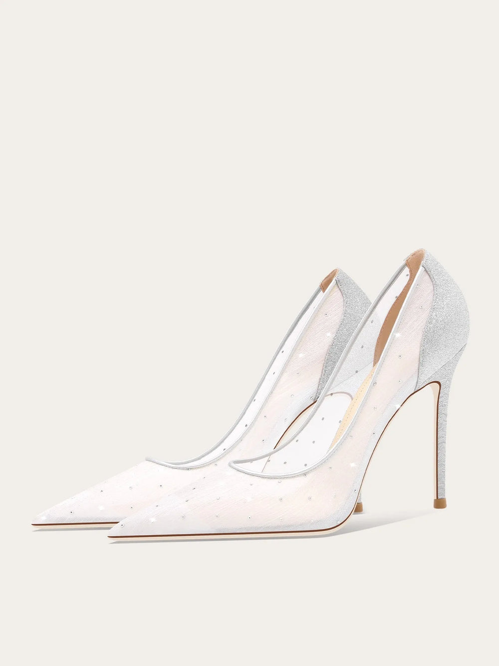White high-heeled shoes with clear straps on a light gray background