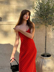 A vintage-inspired red polka dot dress with a square neck, backless design, and a slim fit.