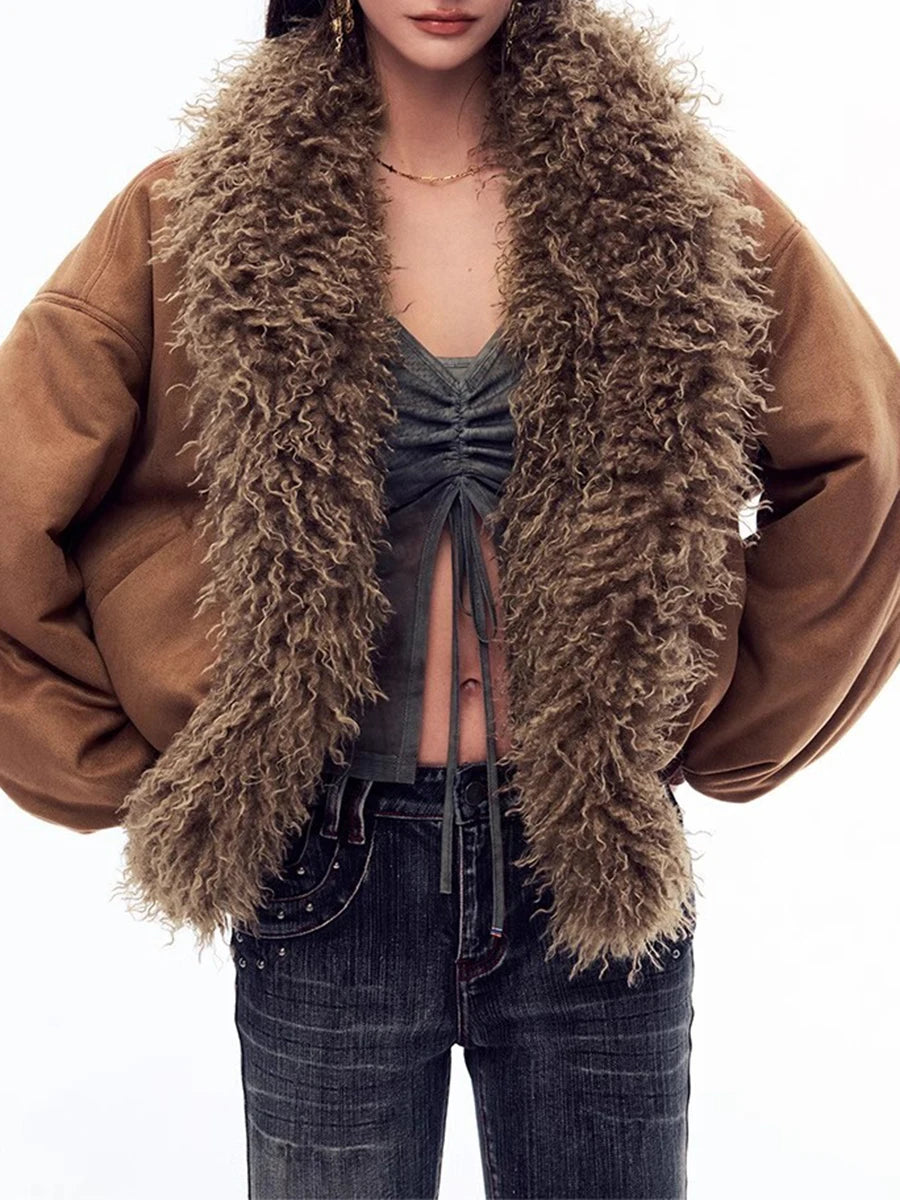 Person wearing a brown jacket with a fluffy brown scarf