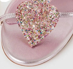 Women’s silver metallic open-toe sandals with glitter heart crystals.