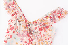 Close-up detail of the ruffled V-neckline and tie on the midi dress.