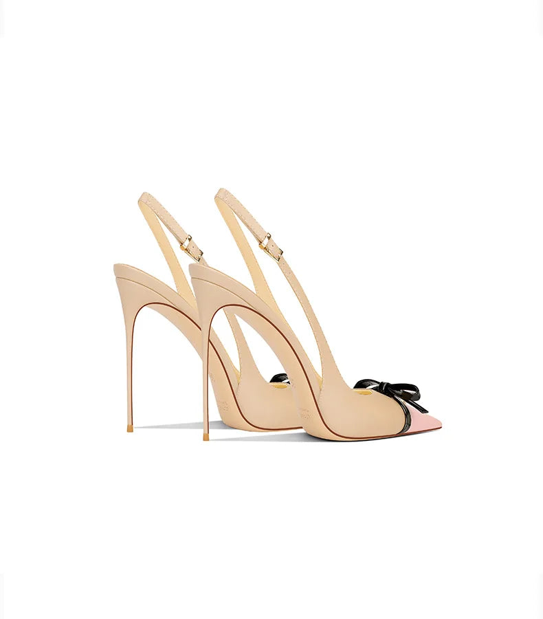 Beige high-heeled shoes with a bow on a white background