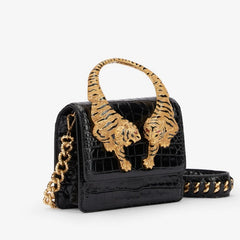Black crocodile effect top handle bag with gold tiger sculptures and chain strap