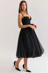 Woman wearing a black tulle dress on a white background