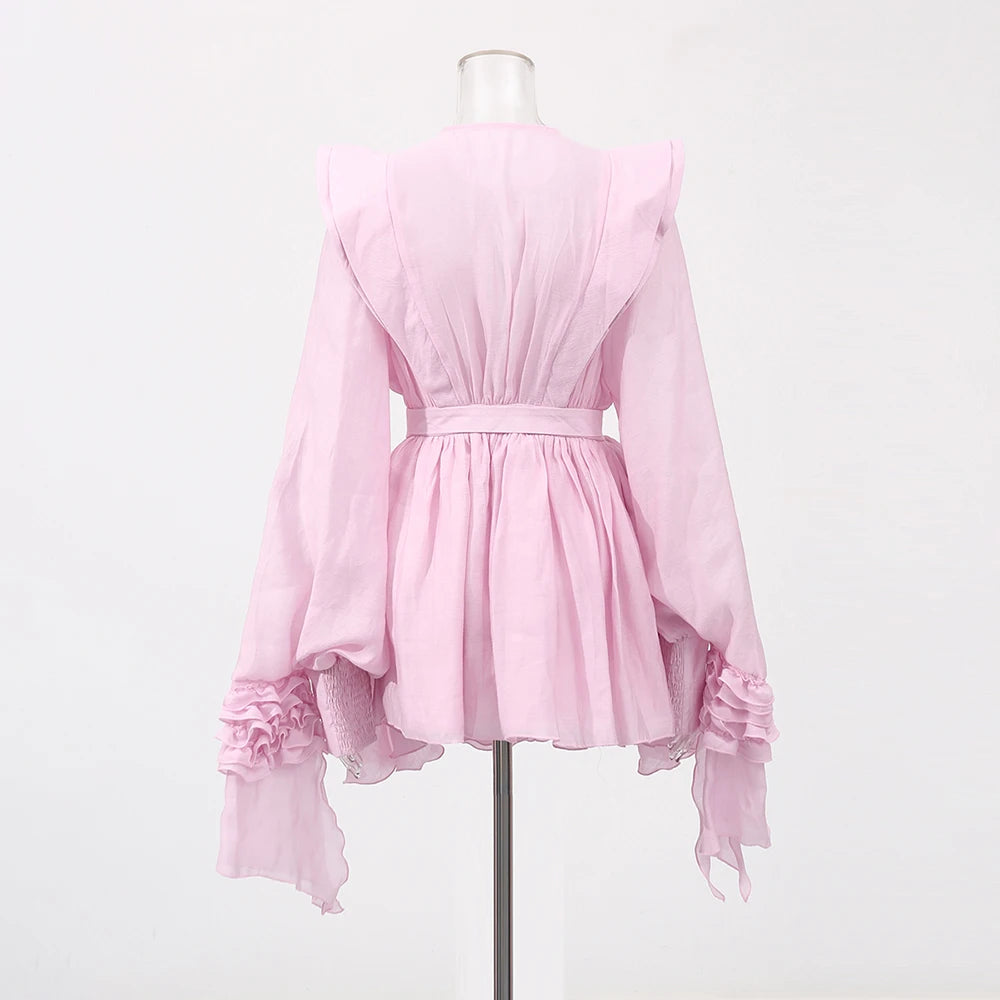 Pink dress on a mannequin against a white background