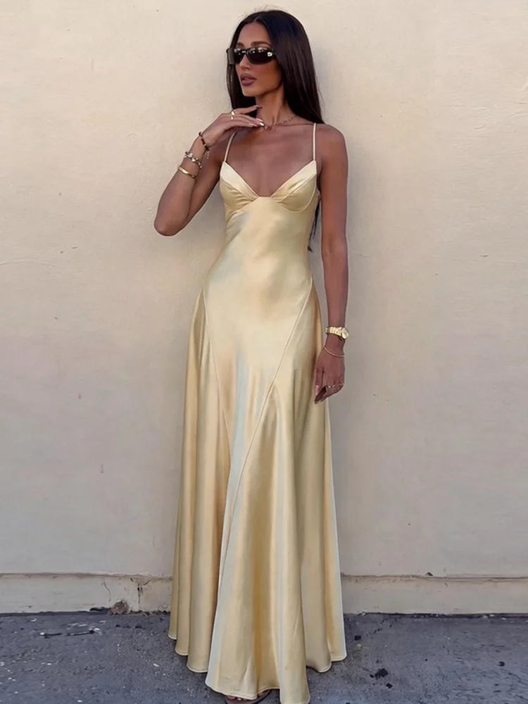 Model wearing a yellow spaghetti strap maxi dress