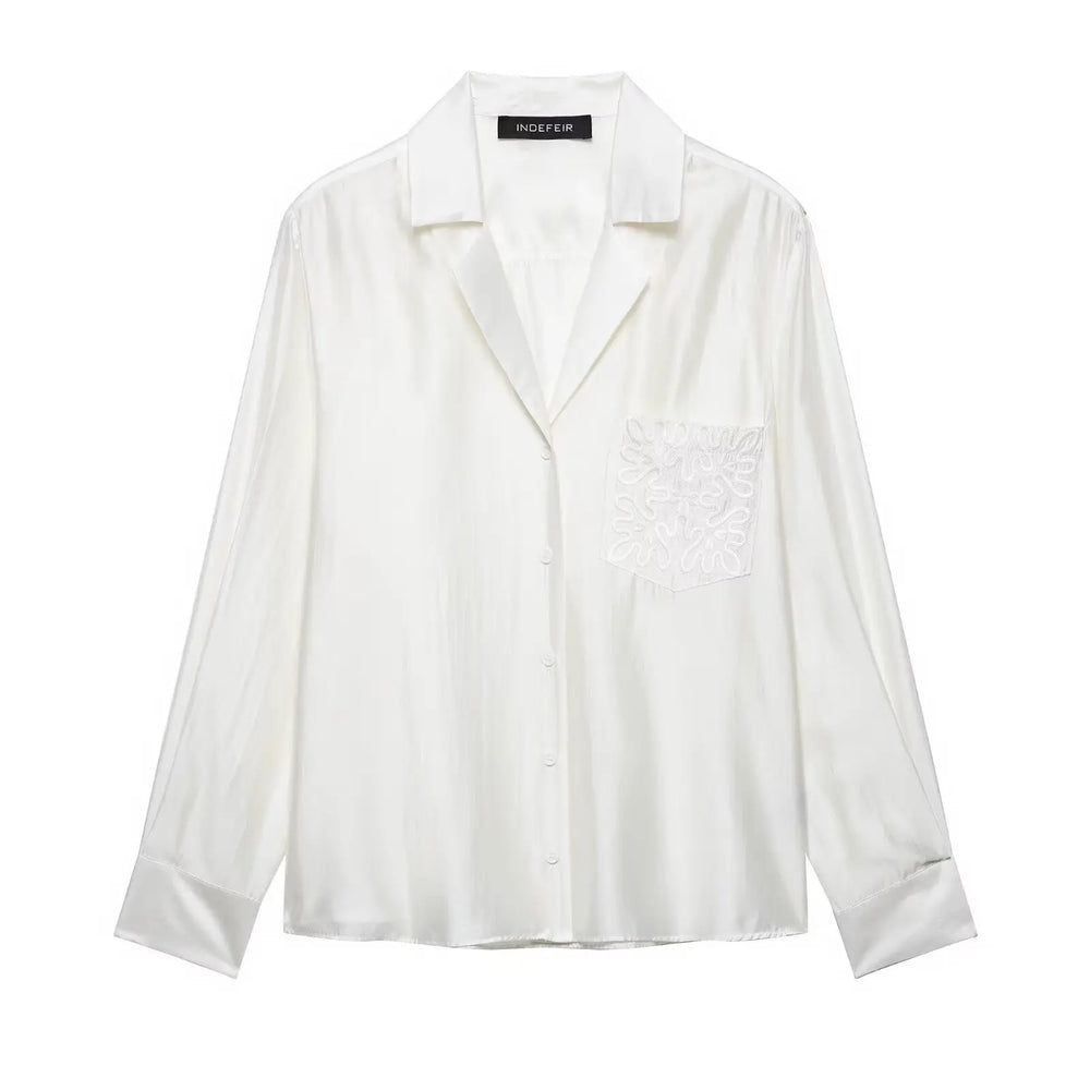 White blouse with lace details on a white background