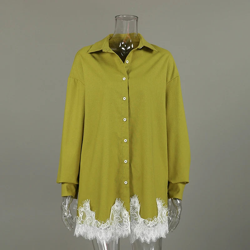 Green shirt with lace cuffs on a mannequin against a gray background