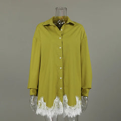 Green shirt with lace cuffs on a mannequin against a gray background