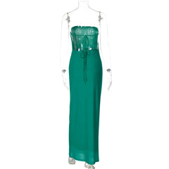 Green evening gown on a mannequin against a white background