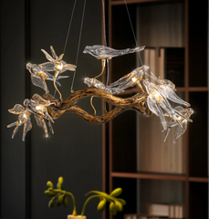Modern chandelier with glass bird-like fixtures on a dark background