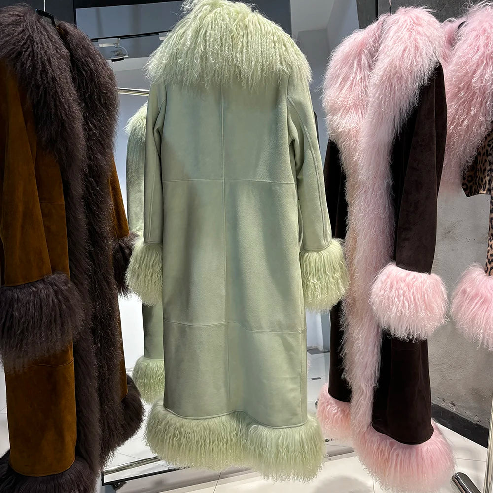 Light green coat with fur trim on a mannequin against a reflective surface.