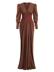 Brown evening gown with intricate waist design on a white background