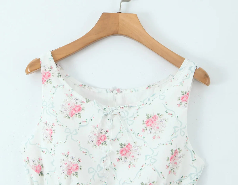 Floral-patterned top on a wooden hanger against a white background