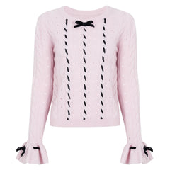 Pink cable knit sweater with black velvet bow embellishments