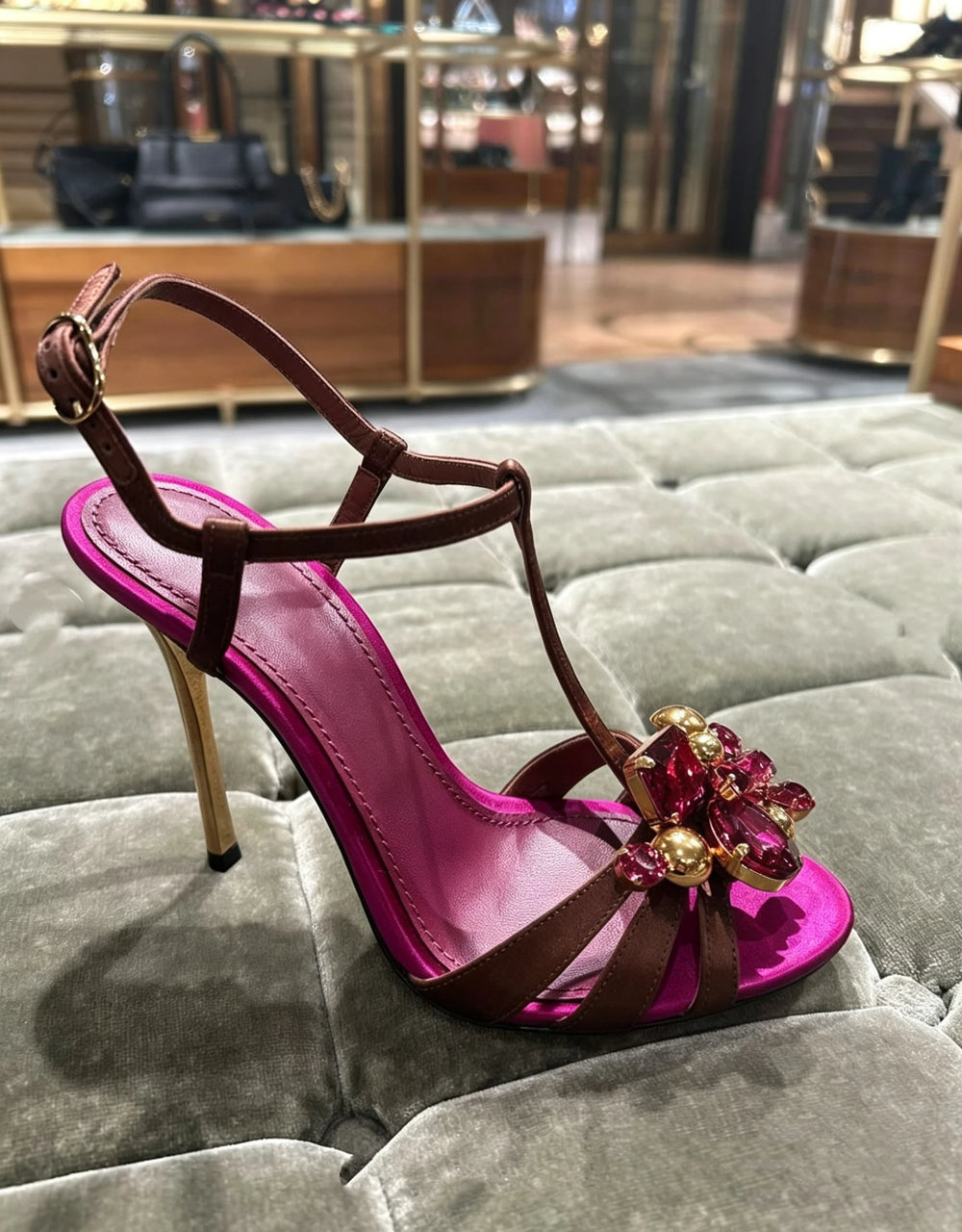 Single stiletto heel with floral rhinestone embellishment on display