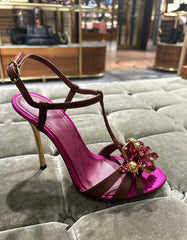 Single stiletto heel with floral rhinestone embellishment on display