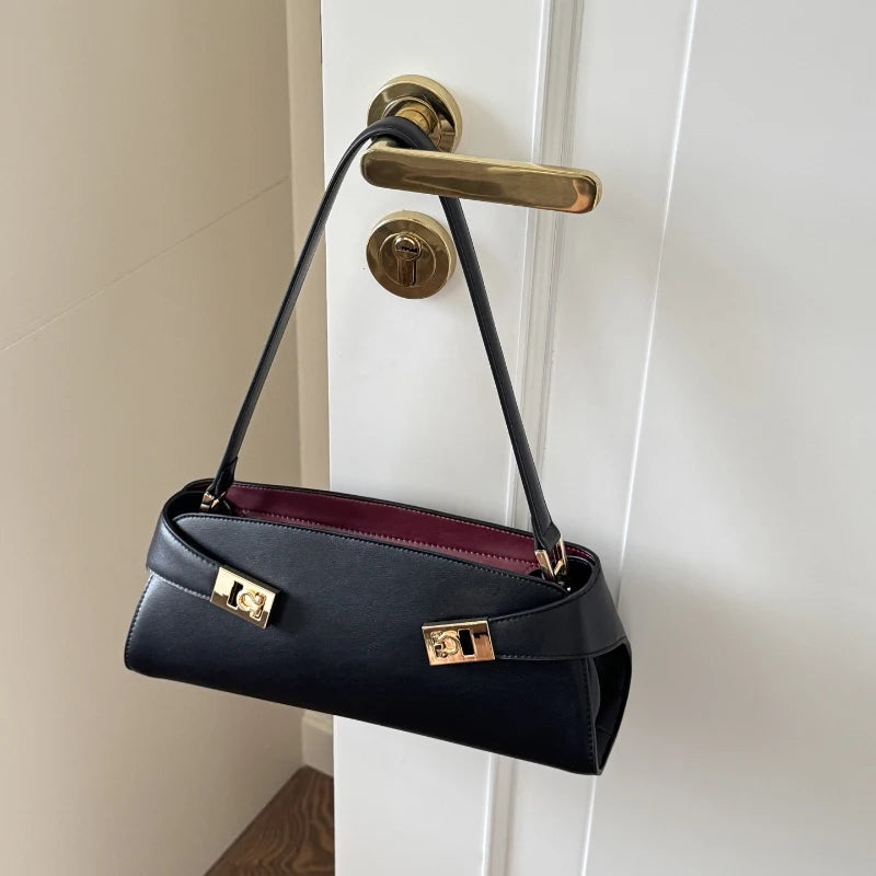 Black leather shoulder bag with gold lock detail