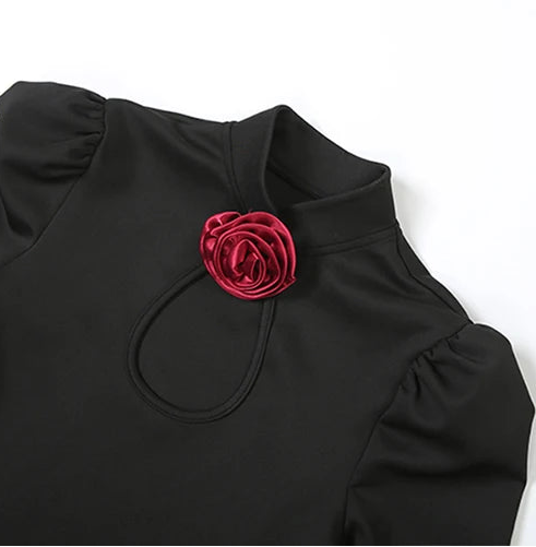 Black long-sleeve DRESS with a red flower accessory 