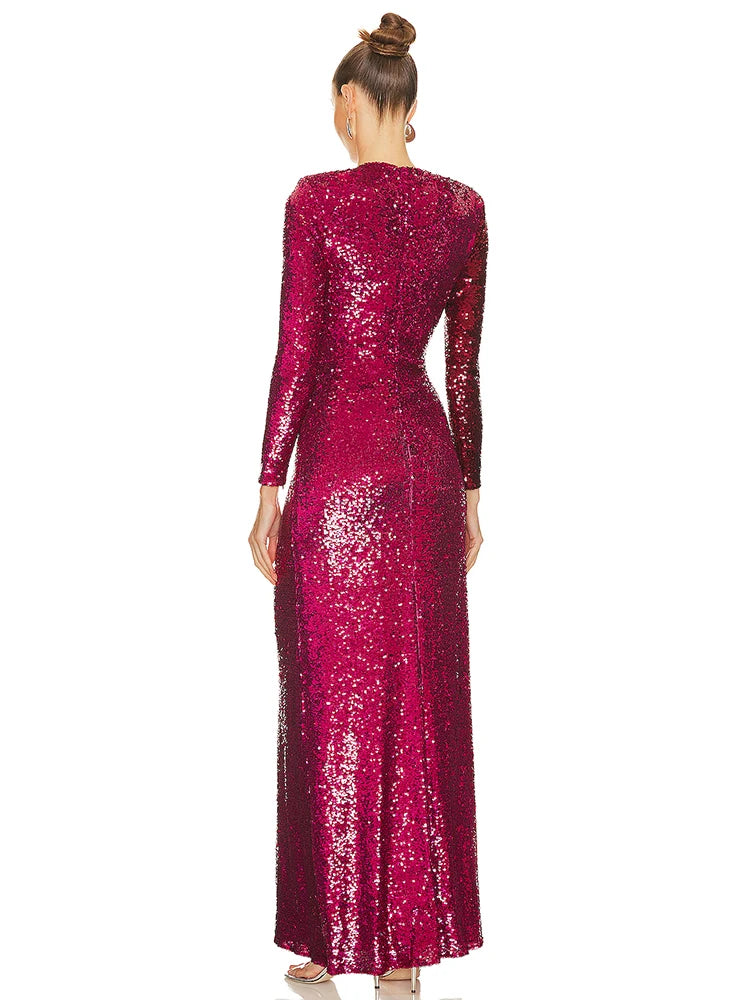 Woman wearing a long, sparkly burgundy dress on a white background