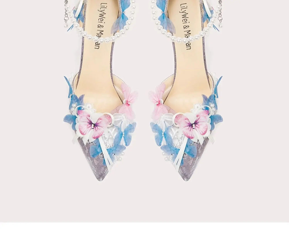 Decorative high-heeled shoes with floral designs and beaded details on a light background