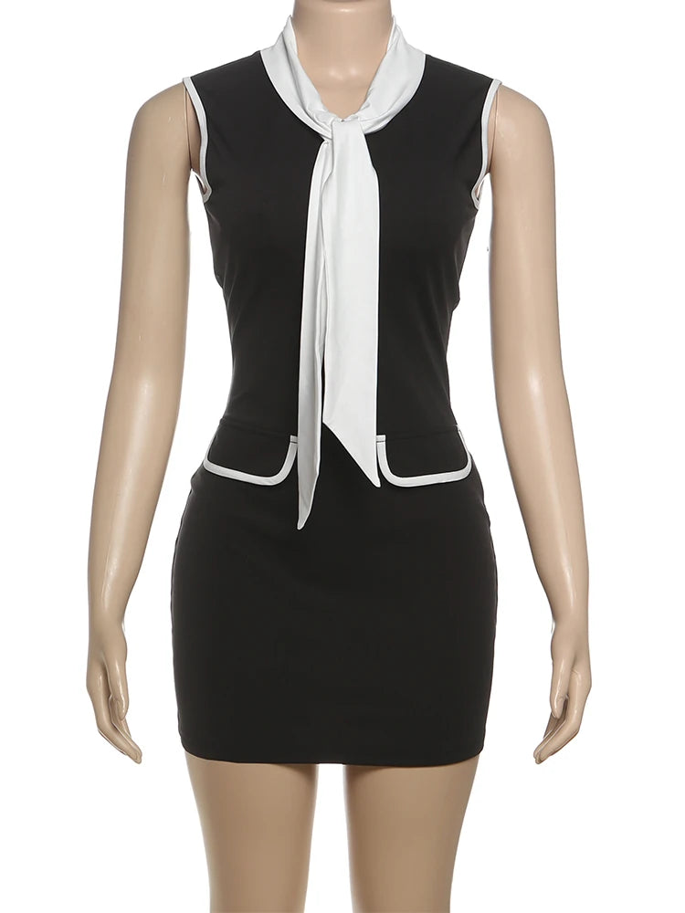 Black dress with a white tie neckline on a mannequin against a white background