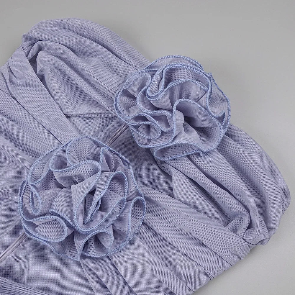 Light purple fabric with floral embellishments on a gray background