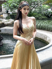 Woman wearing a Sling Pleated Golden Floor-Length Dress from Golden Atelier, showcasing the full length and elegant silhouette.