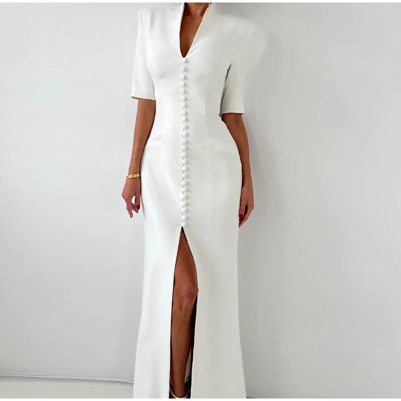 White dress with a front slit on a plain background