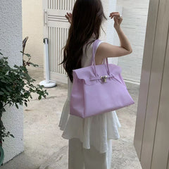 Light purple structured tote bag with lock detail.