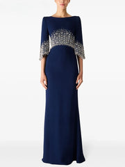 Navy blue evening gown with silver embellishments on a white background