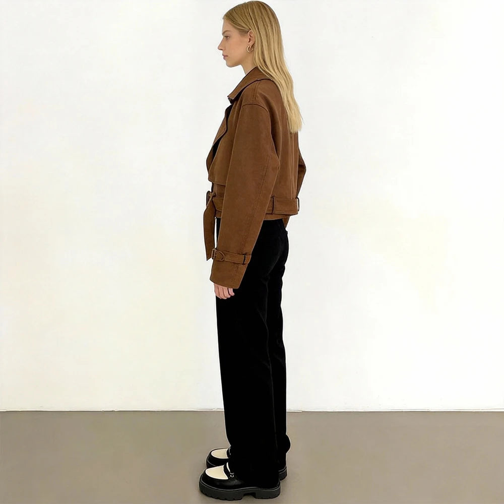 Side view of a woman wearing a brown faux leather cropped jacket