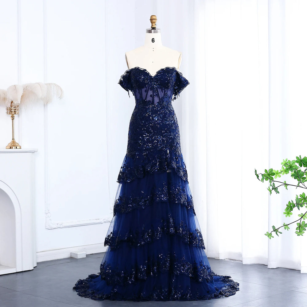 Blue evening gown on a mannequin against a white curtain background