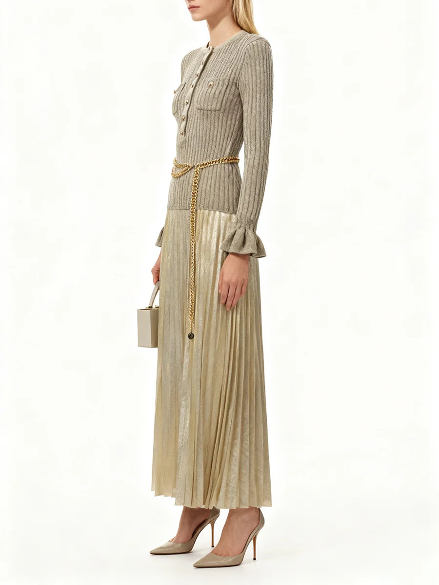 Woman wearing a beige pleated dress with a matching jacket on a white background