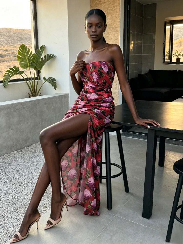 Model sitting in a floral print strapless maxi dress