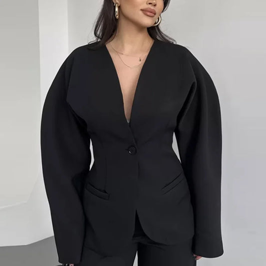 Black blazer worn by a person on a plain background