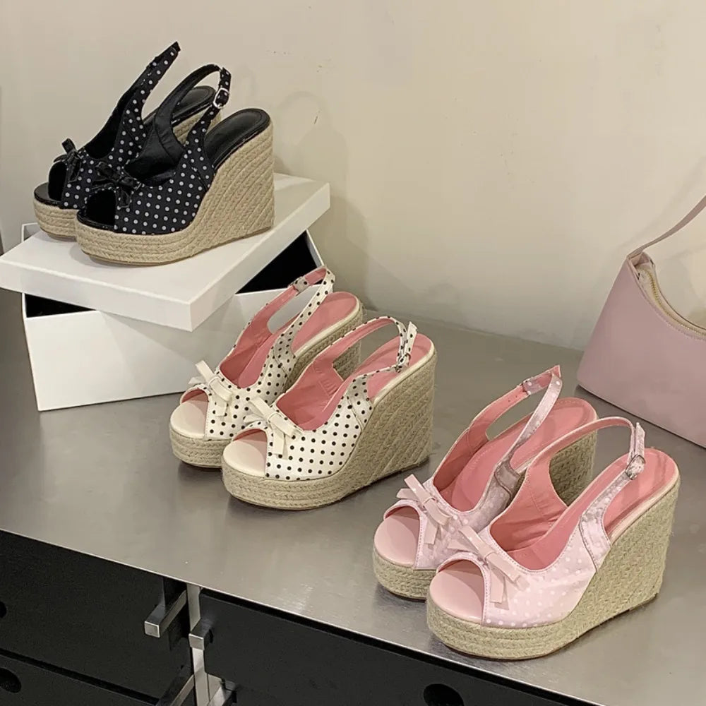 White polka dot wedge espadrille heels with a bow detail and woven sole.
