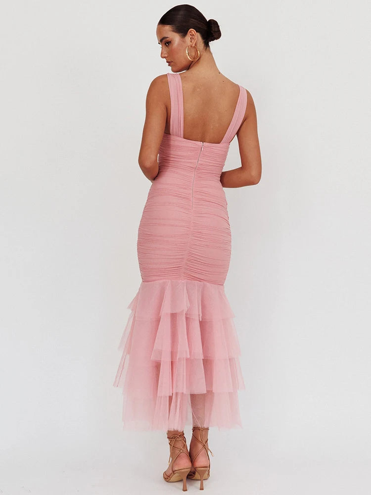 Pink dress with ruched bodice and layered skirt on a white background