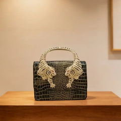 Black embossed leather handbag with sculpted tiger handle