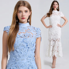 Two women wearing lace dresses, one blue and one white, on a plain background.