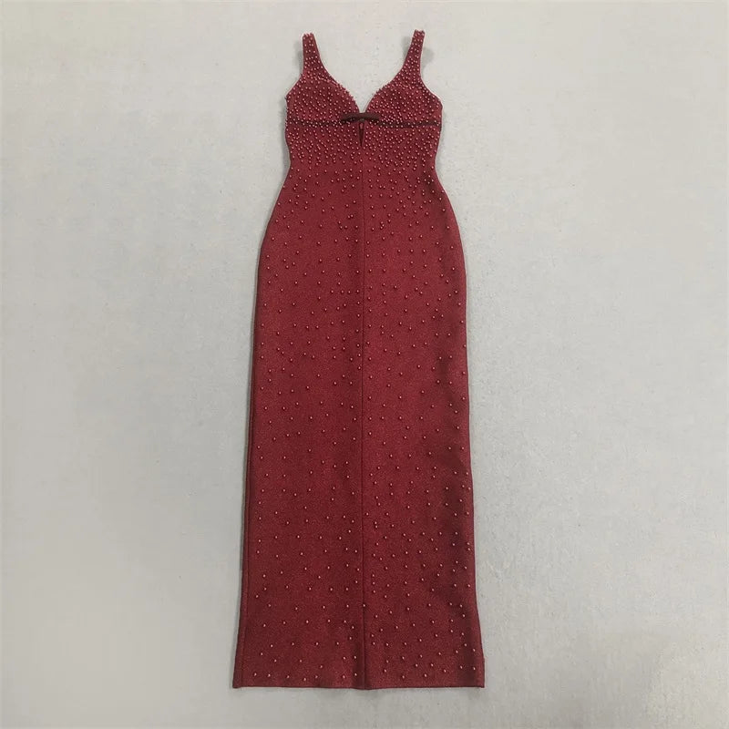 Flat lay of a sleeveless red formal gown with pearl embellishments