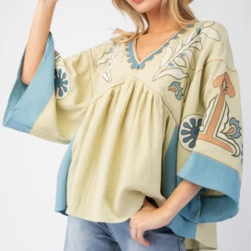 Embroidered V-neck flare sleeve top in pale yellow and blue.