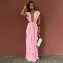 Pink draped plunge neckline maxi dress with side cutouts.
